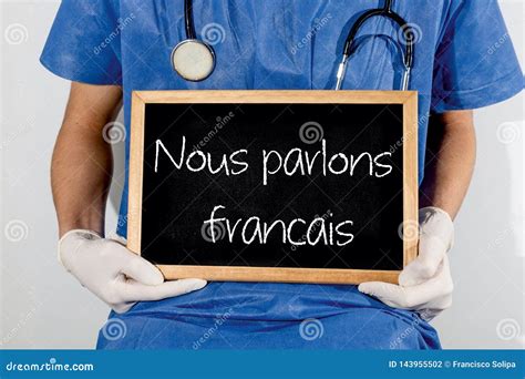Doctor Shows Information on Blackboard: we Speak Francais. Medical ...