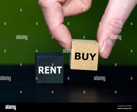 Hand selects the cube with the word buy instead of the cube with the word buy. Symbol for buying ...