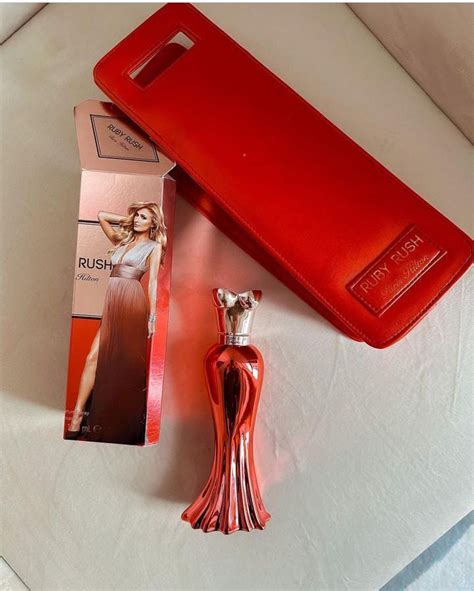 Paris Hilton sizzles in red at the launch of her new fragrance line in ...