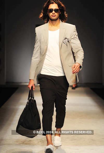 Designers Rohit Gandhi and Rahul Khanna walk the ramp after presenting ...