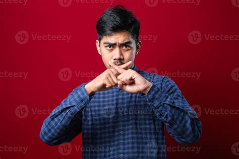 Asian young man with mustache wearing casual shirt rejection expression ...