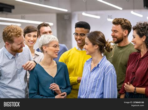 Group of People Standing in a Room Talking 的图像结果