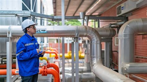 Engineer overseeing industrial cooling systemfactory technician ...