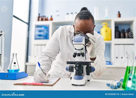 Young African American Man Wearing Scientist Uniform Using Microscope ...
