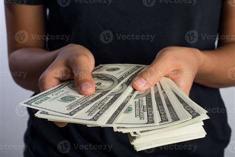 Close-up of a woman's hand holding money isolated on white background ...
