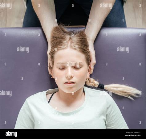 Craniosacral therapy practitioner giving a female patient CST ...