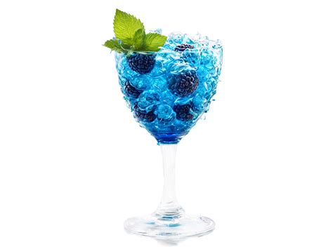 Blue raspberry soda in a twisted glass blue raspberries and mint leaves ...