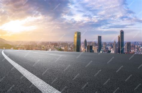 Asphalt pavement and urban building group background | Premium Photo