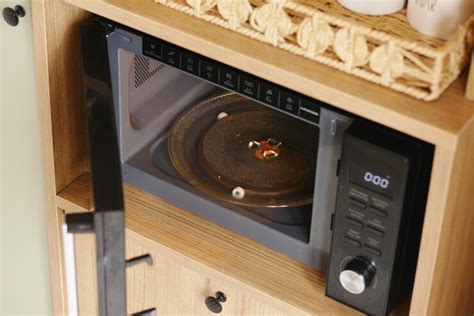 Microwave in kitchen showing food splatters inside during meal prep ...