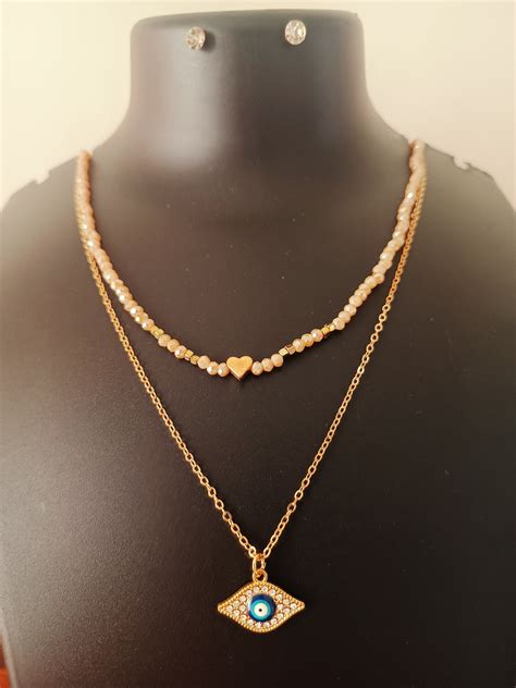 Double layered gold plated beige beads evil-eye neckpiece with earring