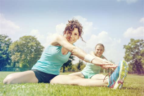 Two Young Girls Stetching before a Jogging Stock Image - Image of ...