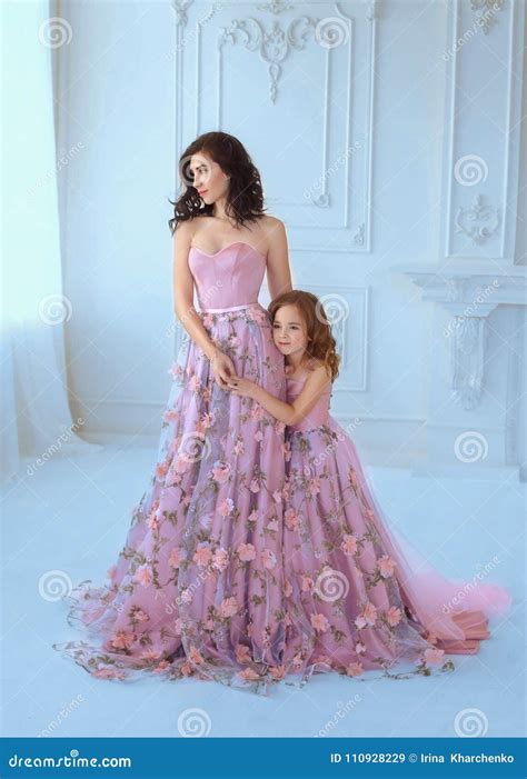 Mom and Daughter in Luxurious, Pink Dresses with Sakura Flowers on a ...