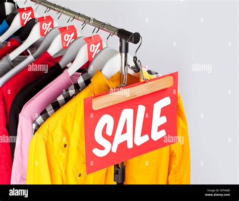 Sale in a clothing store - discount sign at a clothes rack Stock Photo ...