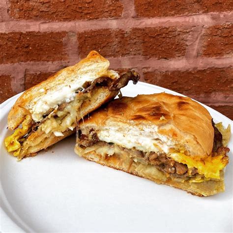 A sandwich on a bolillo roll made with corn tortilla pieces that are ...