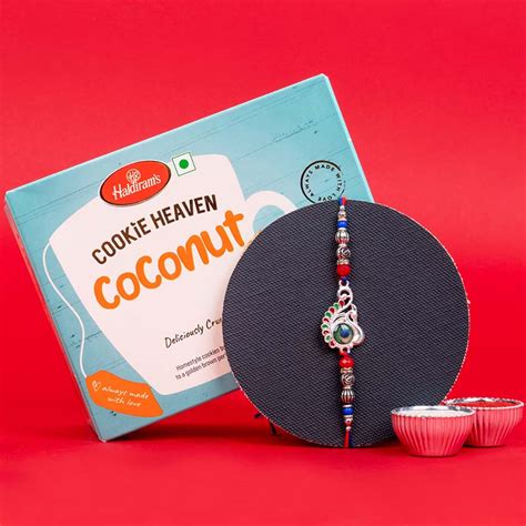 Send Designer Silver Peacock Rakhi with Haldiram''s Coconut Cookies ...