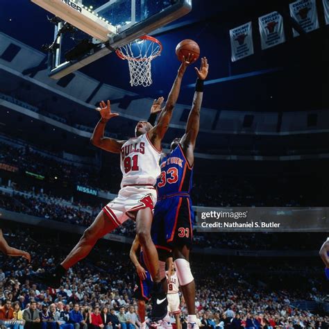 Dennis Rodman of the Chicago Bulls shoots a layup against Patrick ...