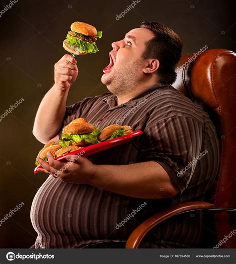 Fat man eating fast food hamberger. Breakfast for overweight person. ⬇ ...
