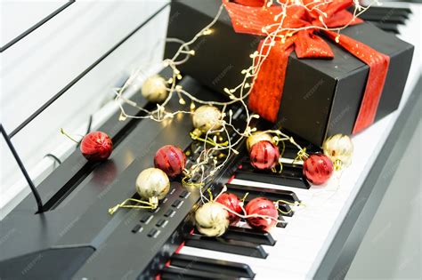 Premium Photo | Piano keyboard with christmas garland close up