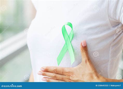Green Ribbon in Hand As Symbol To Awareness Lymphoma Cancer Stock Image ...