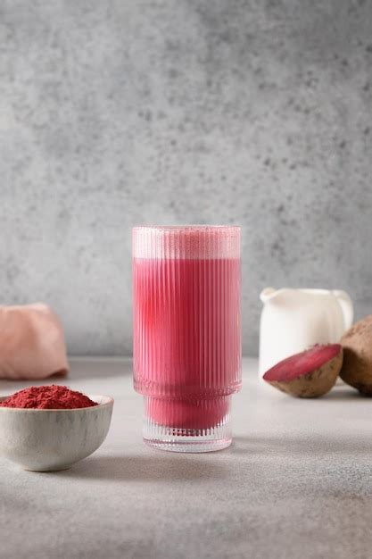 Beetroot latte or pink moon milk latte in glass cup on gray background ...