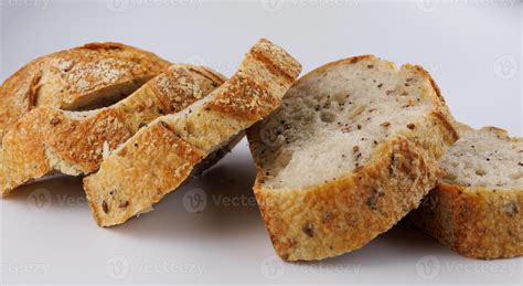 Loaf of bread cut into pieces on a white background. pieces of bread ...