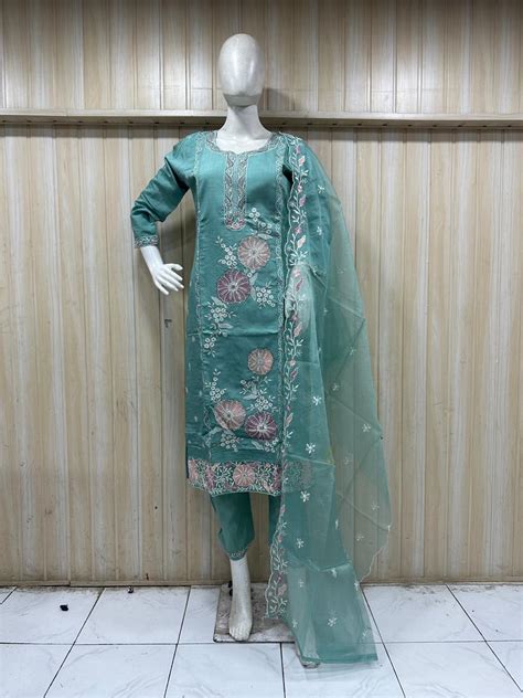 mannequin waering a teal embroidered outfit with a sheer dupatta again ...
