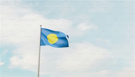 A blue and yellow flag flying in the sky photo – Wallpaper Image on ...