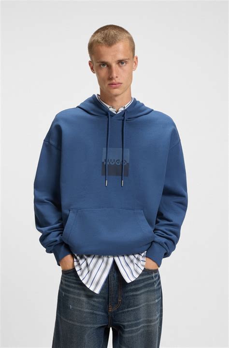 HUGO - Relaxed-fit hoodie in cotton terry with split logo - Blue