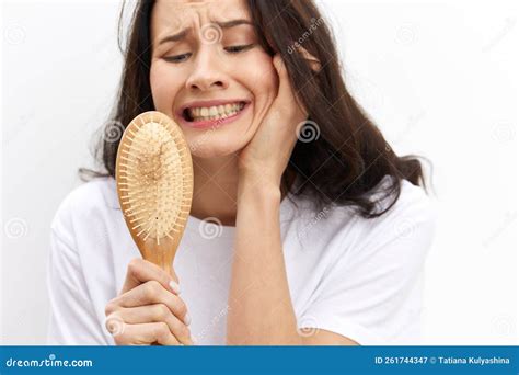 A Close Horizontal Photo of a Woman Holding a Comb with Hair Inside ...