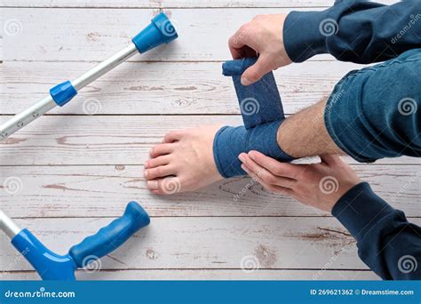 Teenage Boy Wrapping Compression Bandage Around Sprained Ankle. Ankle ...