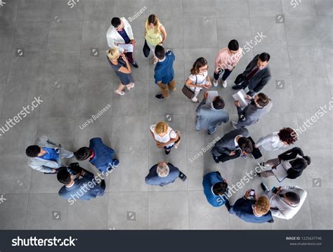Group of People Standing in a Room Talking 的图像结果