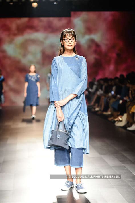 Turning heads with ease, a model looks beautiful as she walks the ramp ...