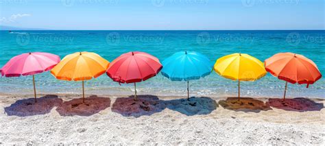 Colorful beach umbrellas on sandy shore. Multiple beach umbrellas by ...