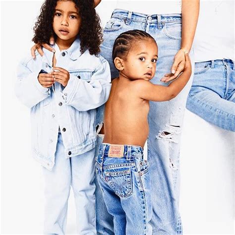 Family first! Saint and North look adorable as they snuggle mom Kim ...