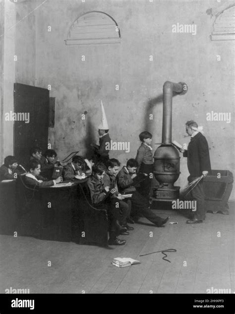An Old Fashioned Boys School with poor boy made to wear dunce cap and ...