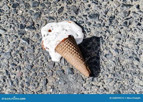 Melted Ice Cream on Sidewalk on Hot Summer Day. Ice Cream in Cone Fell ...