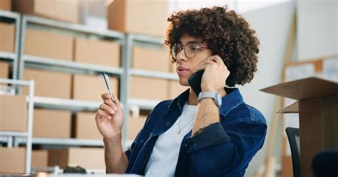 Box logistics and phone call with business man in office for ...