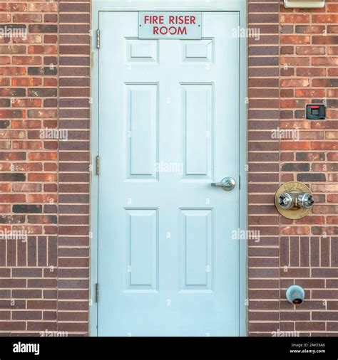 Square frame Fire Riser Room sign on the white wood door of a building ...