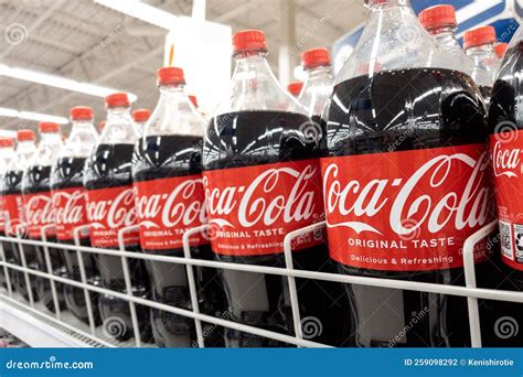 Coca Cola in Bottles on Row Display for Sale in the Supermarket Shelves ...