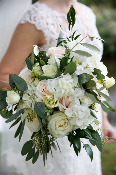 This elegant bridal bouquet was created using white and blush roses ...