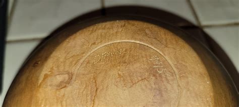 Help with a signature on a vintage wooden bowl : r/Cursive