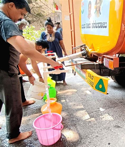 People collect free drinking water from a tanker due to the ongoing ...
