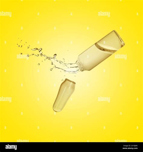 Open ampoule with splashing liquid in air on yellow background Stock ...