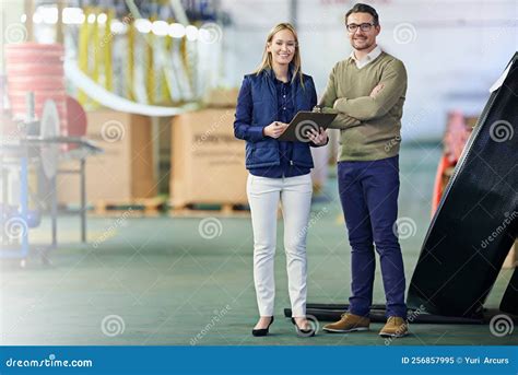 In Control of the Factory Floor. Portrait of a Two Smiling Managers ...