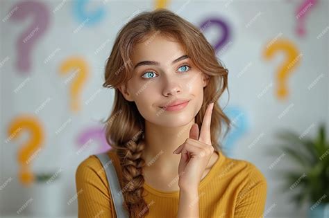 A girl with a braid in her hair is posing with a sign that says ...