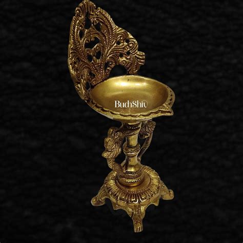 Brass engraved diya with a stand peacock and floral design 9 inch ...