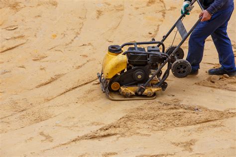 Premium Photo | Worker using vibratory plate compactor for compaction ...
