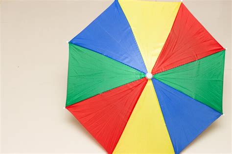 Carnival parasol on the beige background | Premium Photo