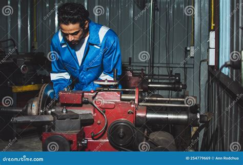 Adult Handsome Male Mechanics Wearing Uniform, Using Machine for Fix ...