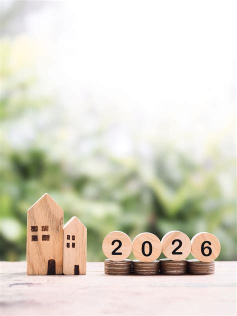 Miniature house and stack of coins the concept of saving money for ...